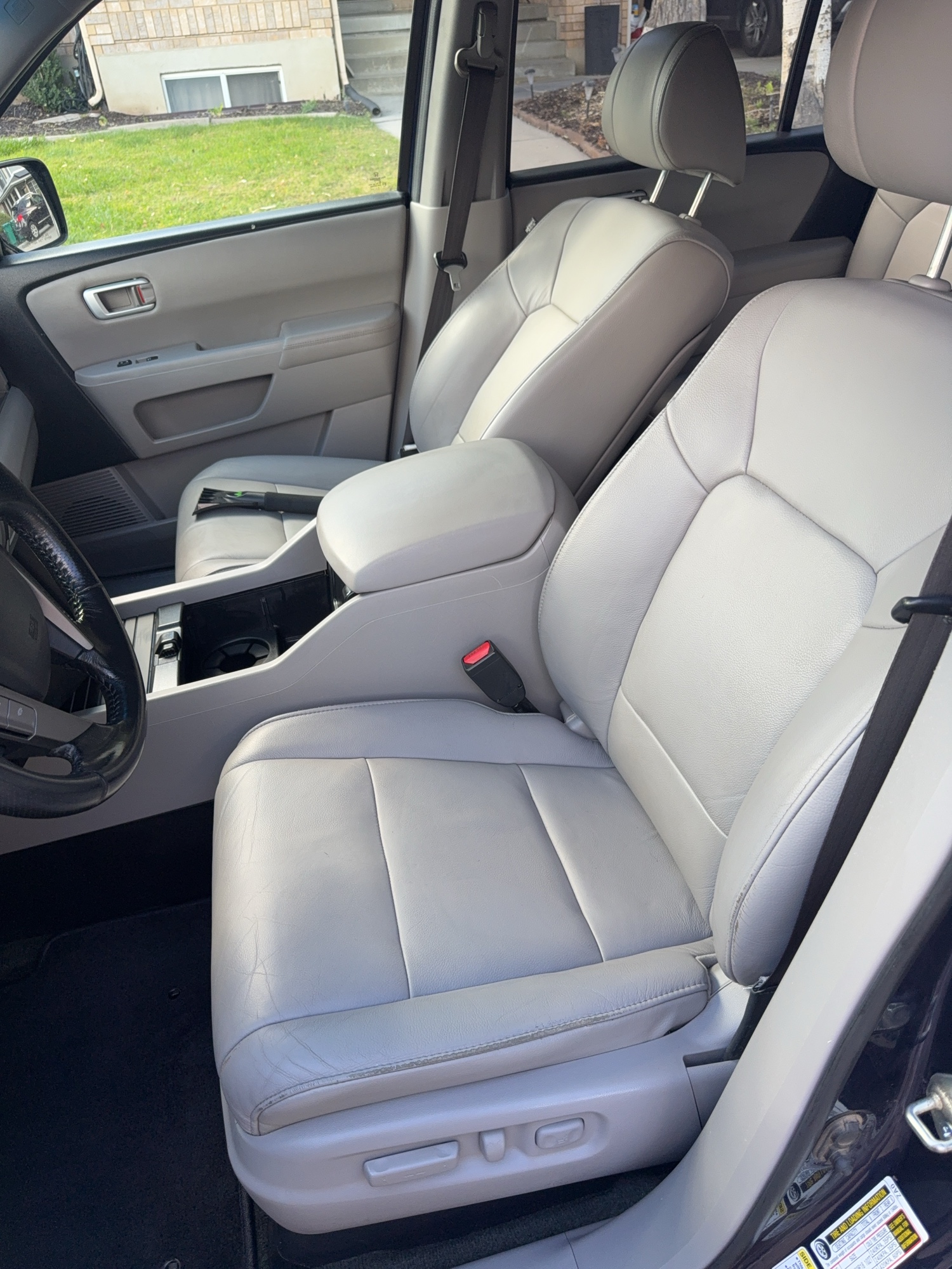 Car leather driver seat before and after deep cleaning and conditioning — after