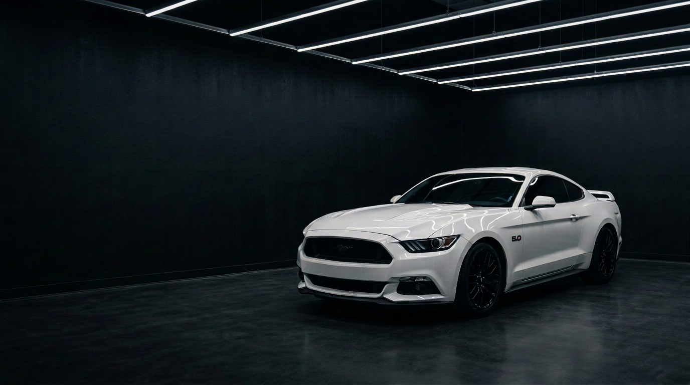 White Ford Mustang under linear detailing lights